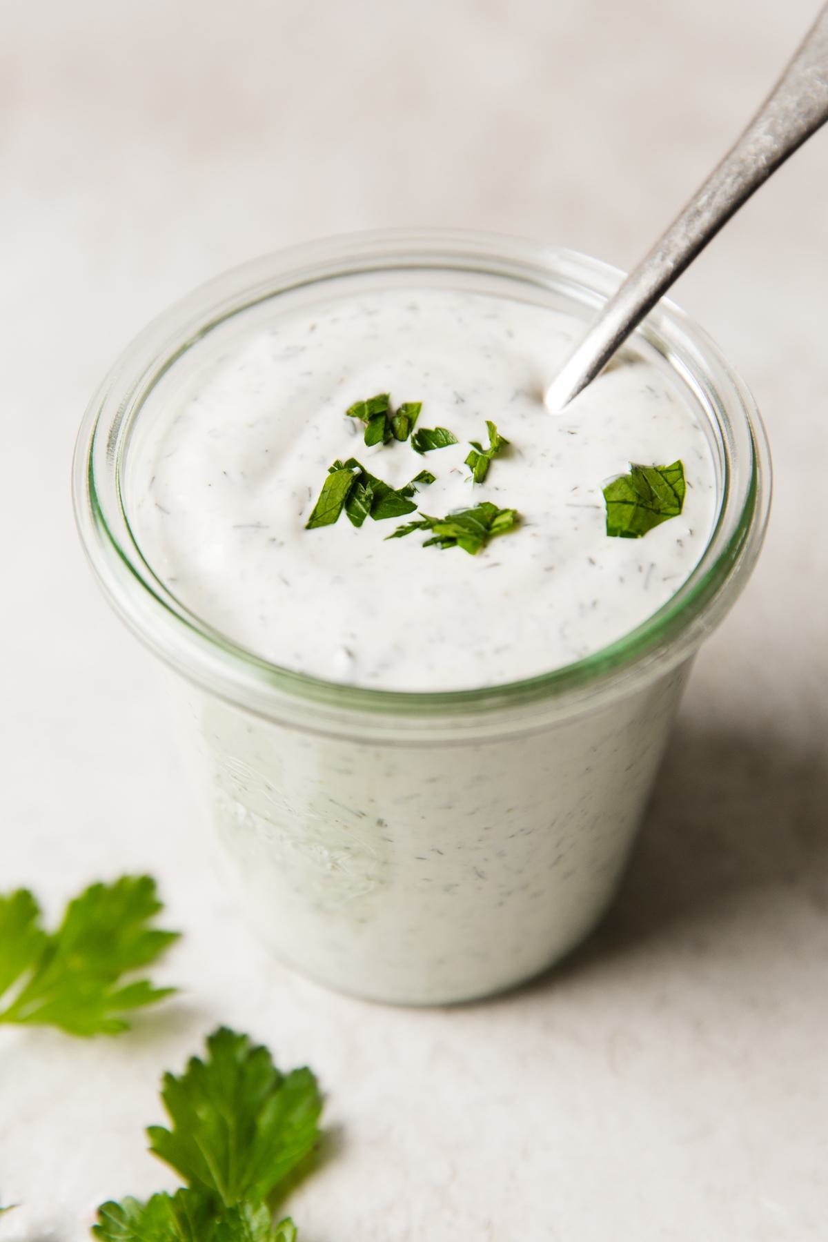 Creamy homemade ranch dressing in a glass jar, ready to elevate any dish with its fresh, herb-infused flavor.